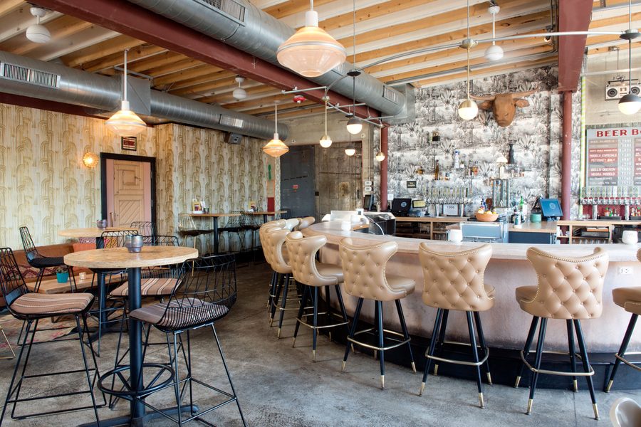Bar stools and patterned wallpaper in the bar room