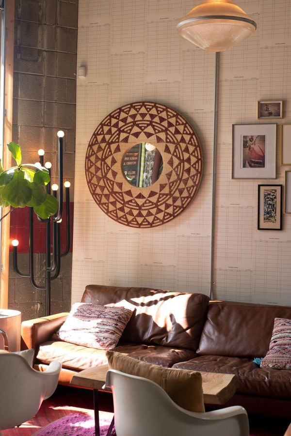 A leather sofa lounge corner with a rattan mirror